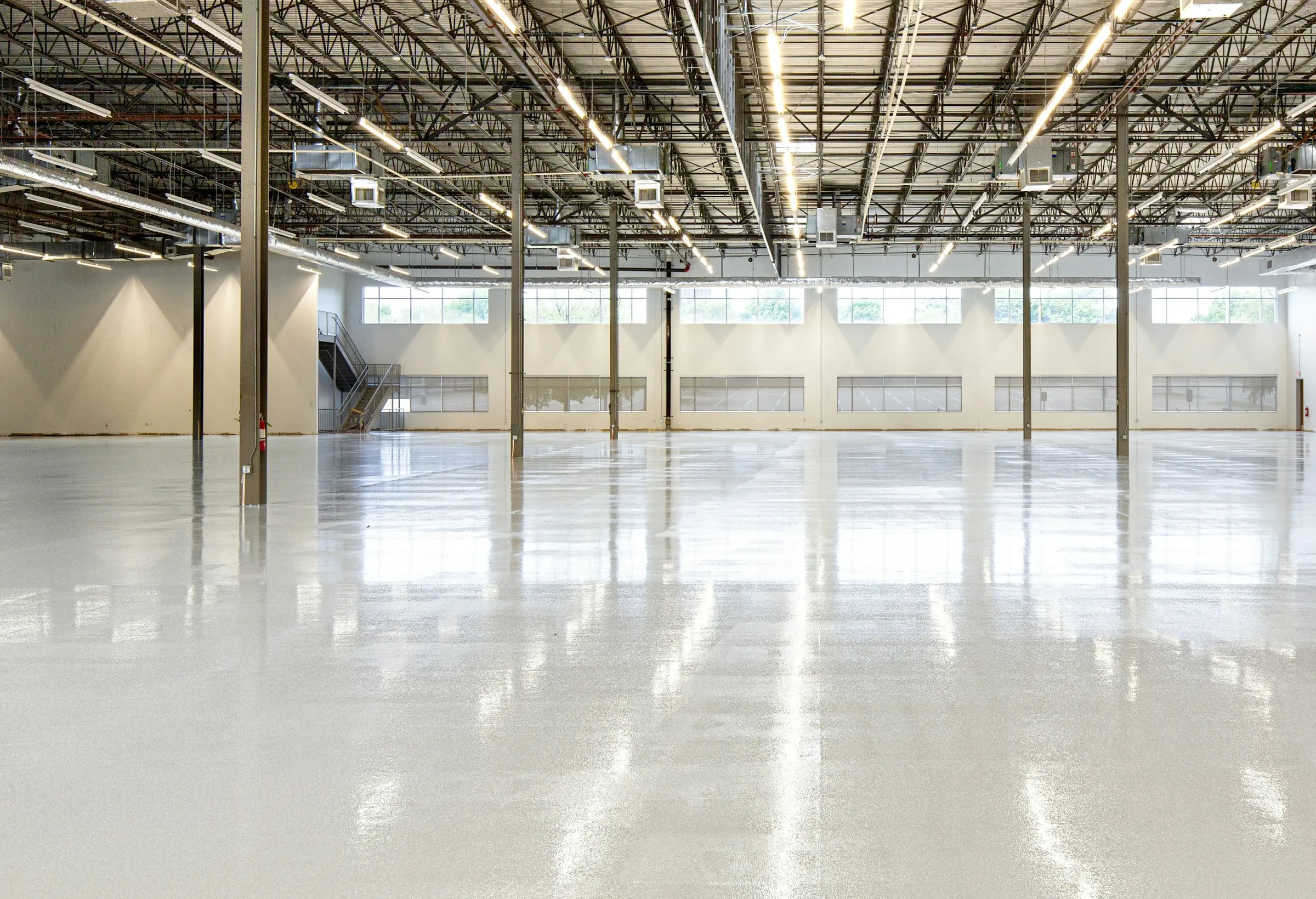 Illustrative photograph: an empty warehouse with a polished floor